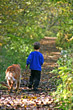 Boy Walking on Path with Dog
