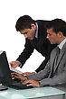 Male Duo Of Male Executives Working On Laptop - stock photo