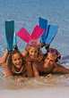 Stock Photo : Beach Pictures: Family laying on the beach sand
