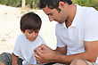 Father Teaching Son How To Fish