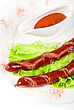 Stock Photo : Meat Pictures: Grilled Sausage Closeup With Lettuce And Sauce Isolated On White