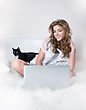 Stock Photo : Face Pictures: Happy Young Female In White Bed With Black Kitten And Laptop Sitting. Series Of Photos