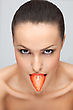 Portrait Of A Young Pretty Lady With A Fresh Strawberry In Her Mouth