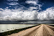 Weather Storm Clouds Saskatchewan Billowing Clouds And Gravel Road - stock photography