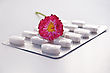 Stock Photo : Packing Stock Photo: White Round Pill In A Package With Daisy Isolated On Gray Background